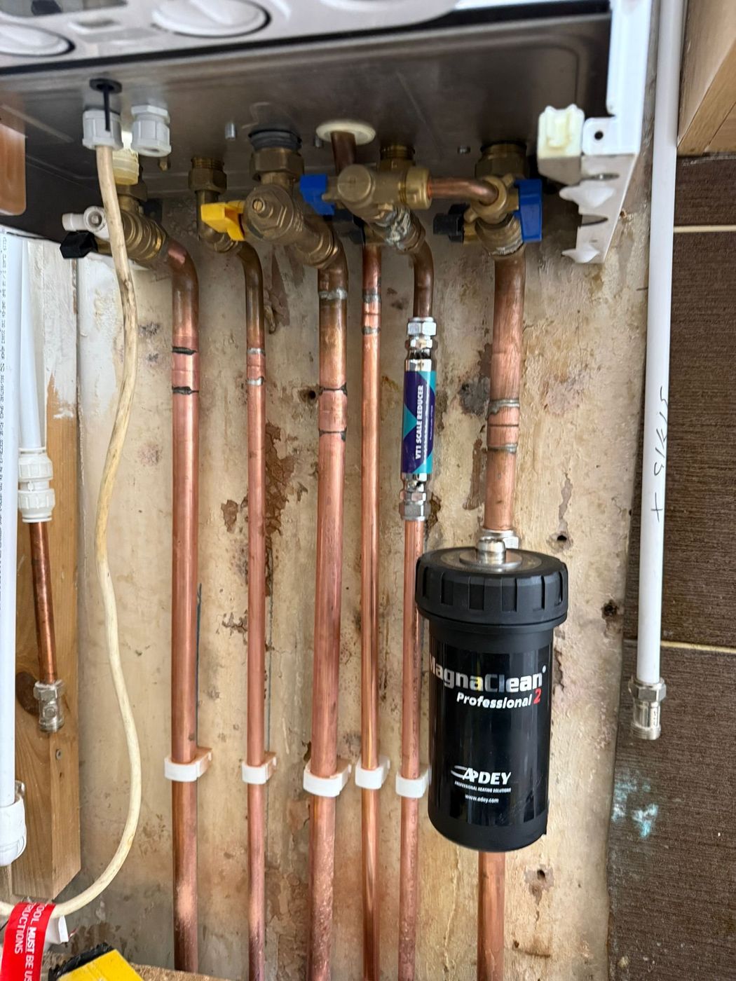 Magnetic system filter fitted to boiler pipework during a service